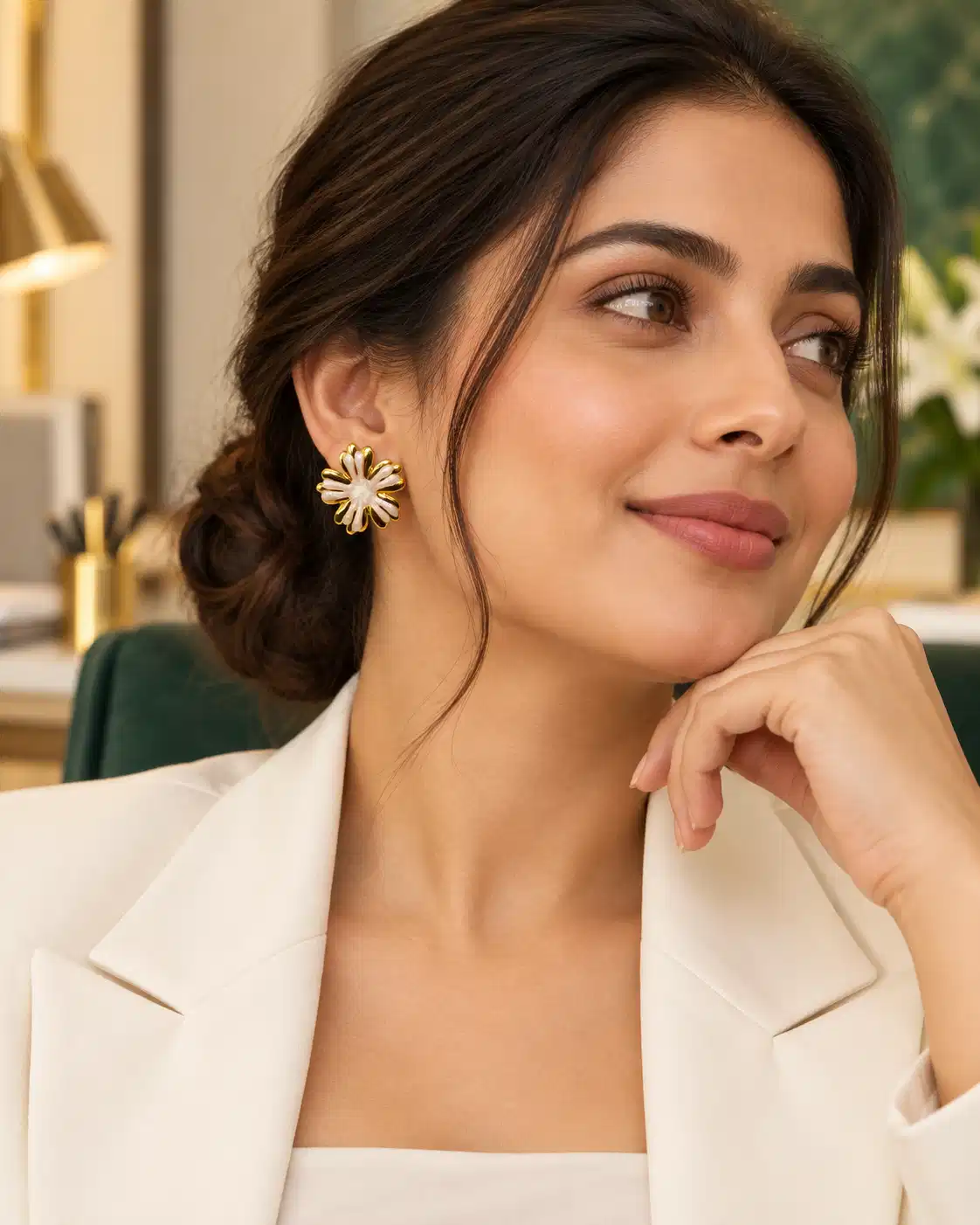 Woman wearing Aurelia Ivory Bloom white and gold floral stud earrings with a white blazer for office wear
