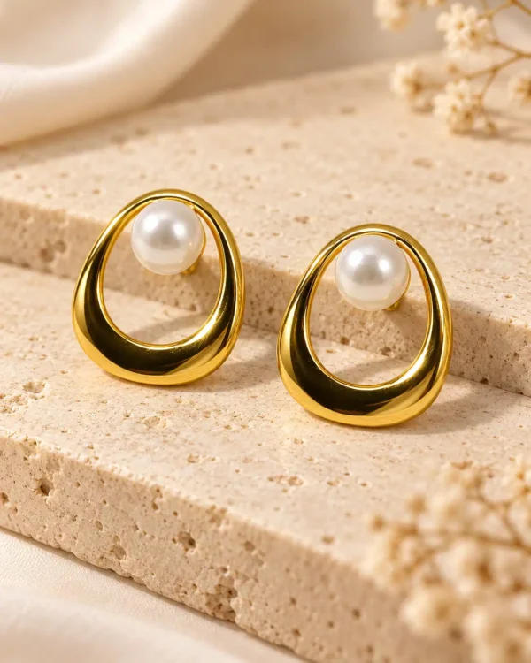 Pair of gold-plated open-loop pearl stud earrings with polished teardrop-shaped frames