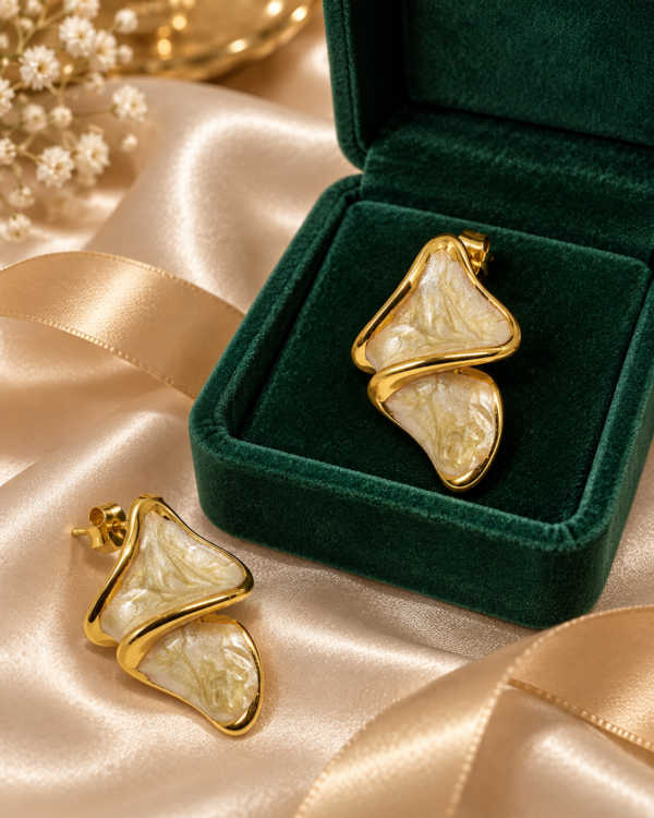 Aurelia Ripple gold and ivory stud earrings styled with green jewellery box and champagne satin