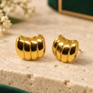 Pair of glossy gold-tone ribbed dome stud earrings with a compact segmented design