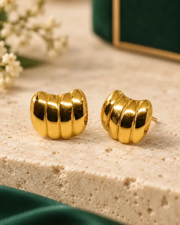 Pair of glossy gold-tone ribbed dome stud earrings with a compact segmented design