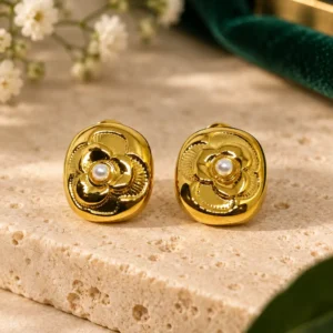 Pair of Camellia Pearl Bloom anti-tarnish gold floral stud earrings with small white pearl centres