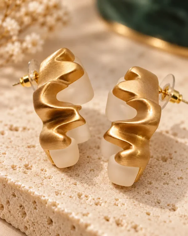 Ivory Wave sculptural earrings showing gold wavy detailing, translucent white sections and stud back
