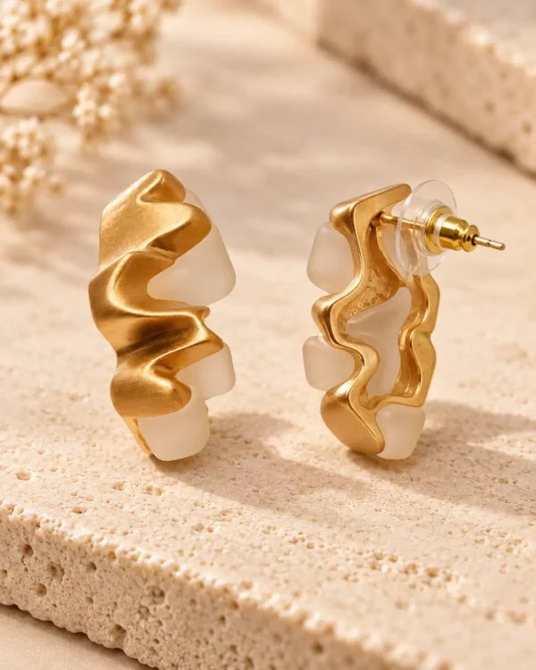 Side and back view of gold and ivory sculptural stud earrings showing post fastening