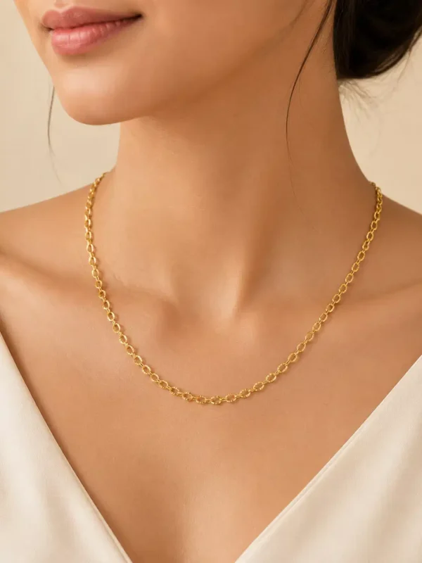 Woman wearing Aurelia anti-tarnish gold loop chain necklace with delicate textured links and minimalist everyday styling