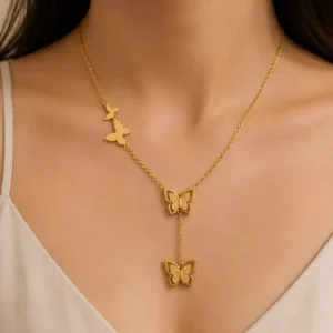 Woman wearing Evolve gold butterfly drop pendant necklace with asymmetric butterfly details
