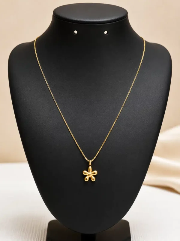 Aurelia Bloom floral pendant necklace displayed on black jewellery bust