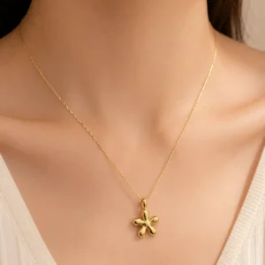 Woman wearing Aurelia Bloom anti-tarnish gold floral pendant necklace