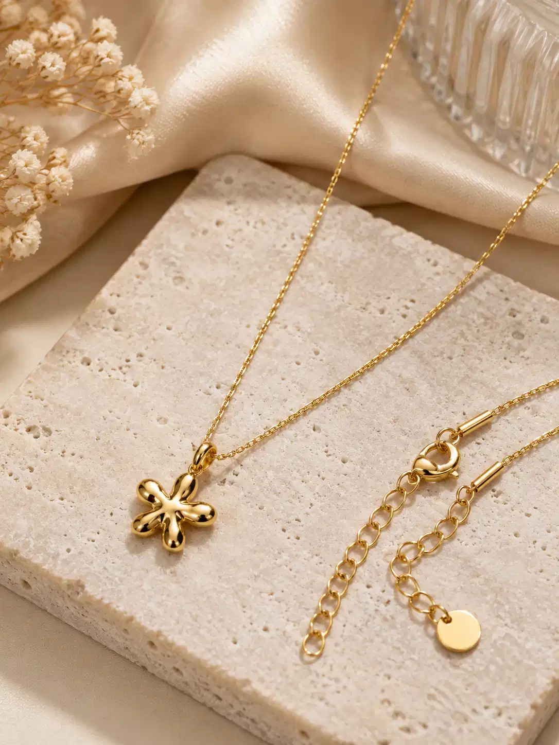 Aurelia Bloom minimal gold floral pendant necklace styled on stone