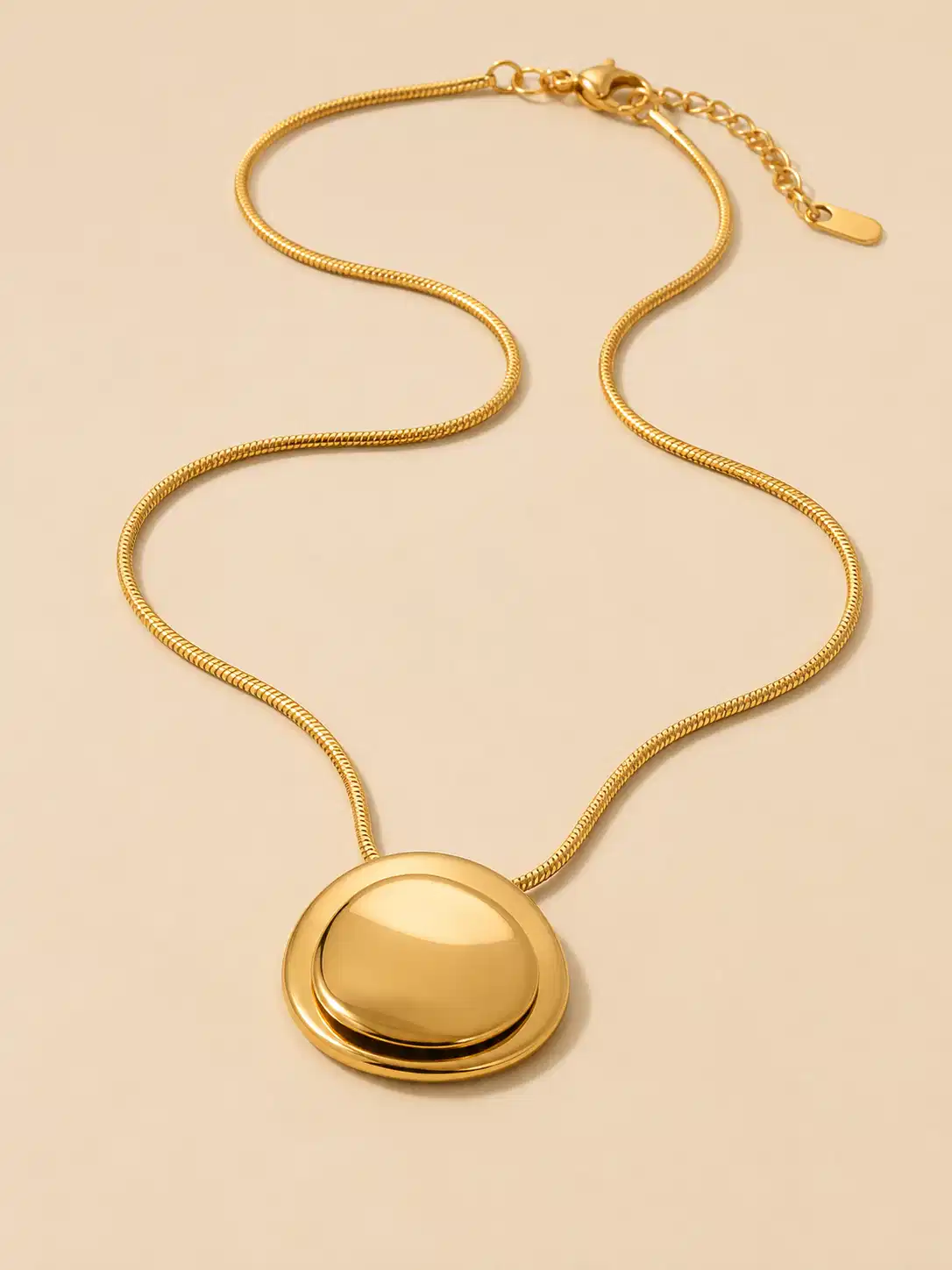 Full view of Blume Golden Orbit round gold pendant necklace with snake chain, lobster clasp and extender