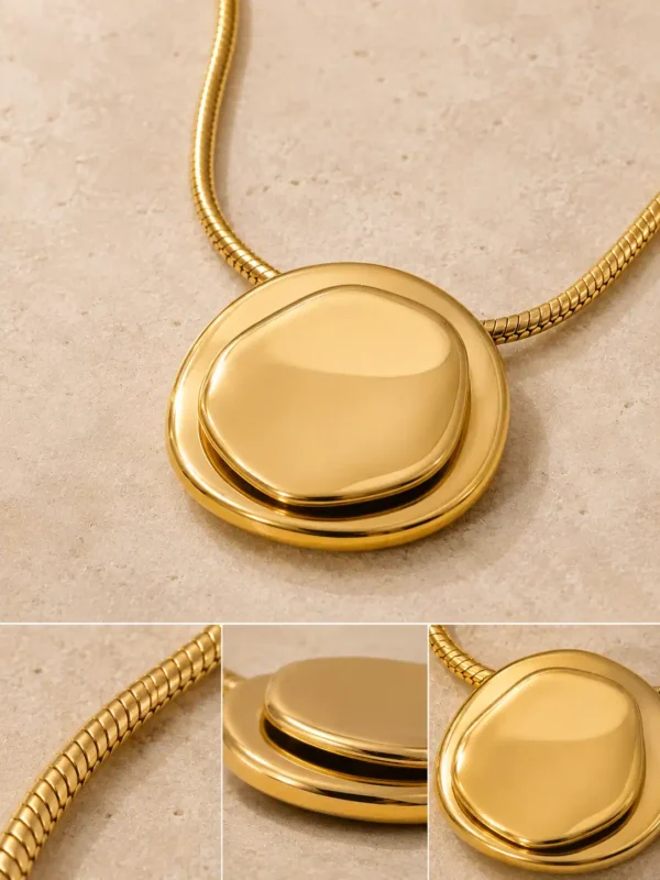 Detail views of Blume Golden Orbit domed gold pendant and slim snake-style necklace chain