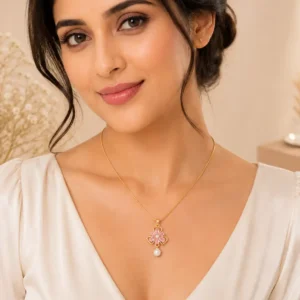 Woman wearing Rosé Bloom anti-tarnish pink crystal flower pendant necklace with pearl drop