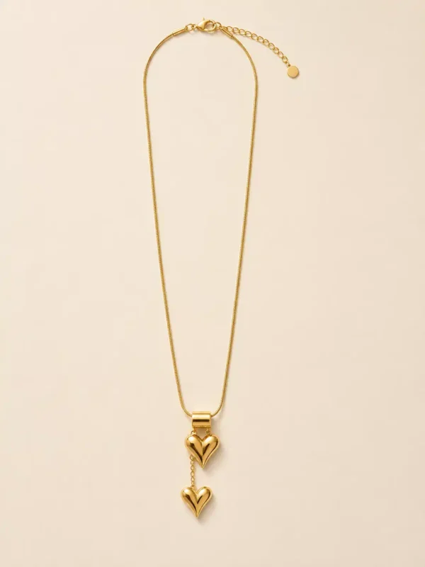 Full-length Amora gold double heart necklace with adjustable extender and two hanging heart charms