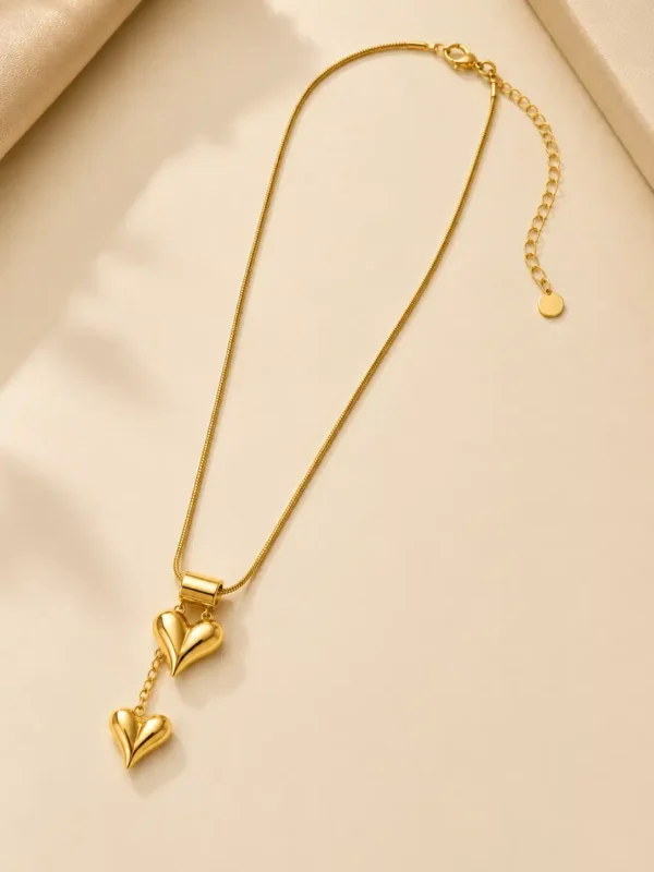 Full view of gold double heart necklace with snake chain, lobster clasp and extender chain