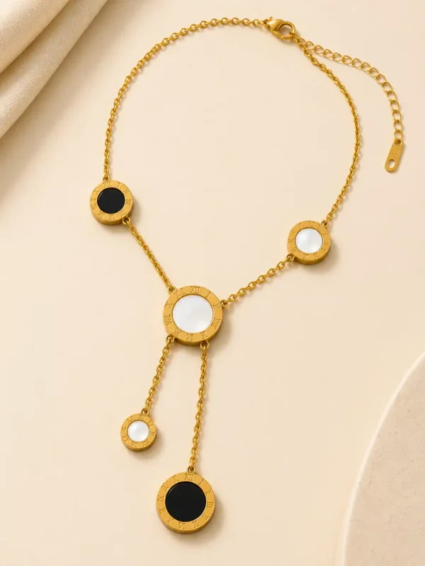 Full Vera gold lariat necklace with black and white circular Roman numeral accents, lobster clasp and extender chain