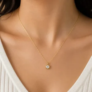 Elara anti-tarnish solitaire pendant necklace worn on the neckline with a delicate gold-tone chain and round clear crystal