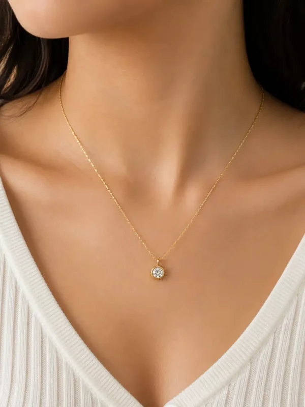 Elara anti-tarnish solitaire pendant necklace worn on the neckline with a delicate gold-tone chain and round clear crystal