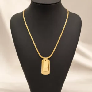 Linea gold-tone layered rectangular pendant necklace on a black jewellery bust, showing the full snake chain and three stacked pendant plates