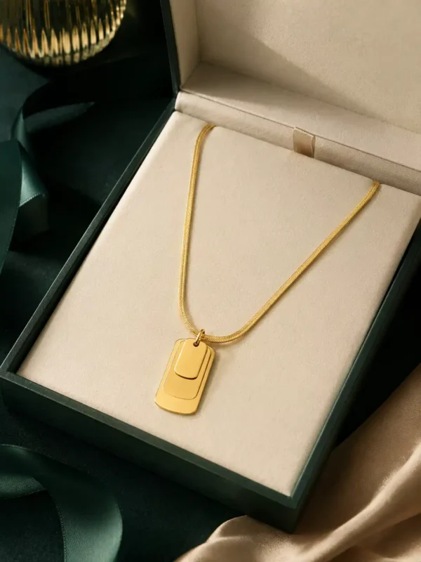 Linea layered rectangular pendant necklace displayed in a dark green jewellery box with a cream interior