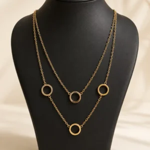 Anti-tarnish gold-plated dual-layer necklace with four open circle charms displayed on a black jewellery bust