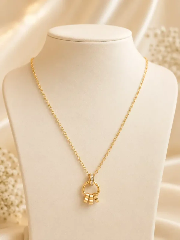 Elara anti-tarnish gold pendant necklace with crystal-accented circular charm and three dangling gold details