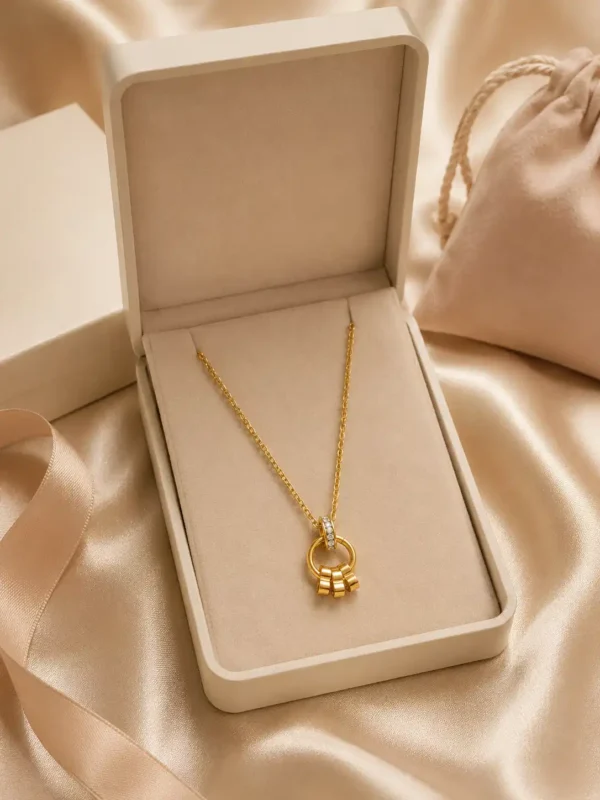 Elara anti-tarnish gold charm necklace presented inside a cream jewellery gift box