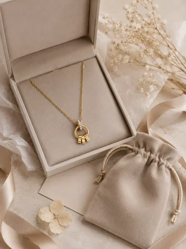 Elara gold pendant necklace displayed with cream jewellery box, pouch and ribbon