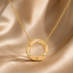 Gold circle pendant necklace with three crystal accents and screw motif detailing on a fine chain