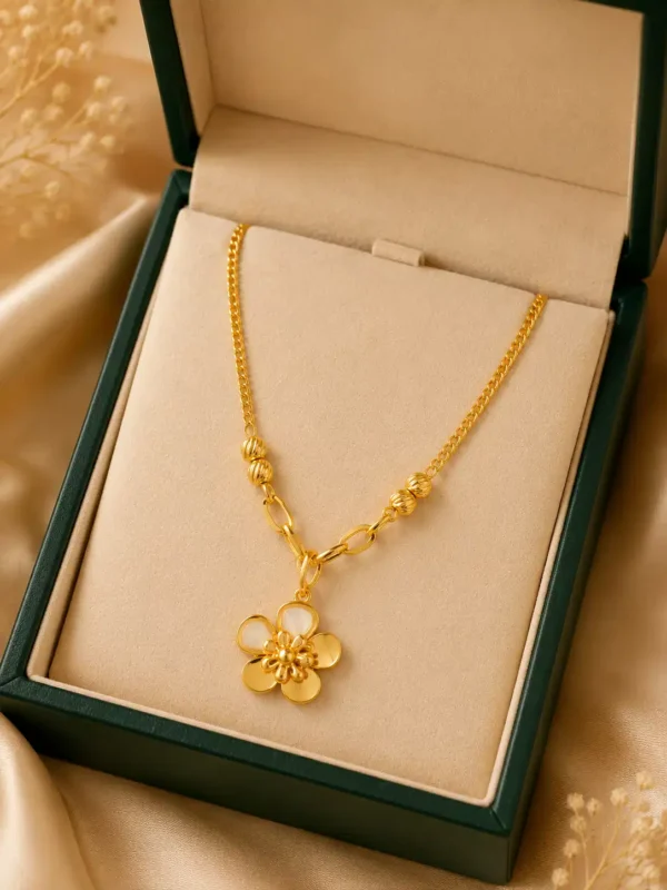 Elara Bloom anti-tarnish gold flower pendant necklace displayed inside a cream and dark green jewellery box