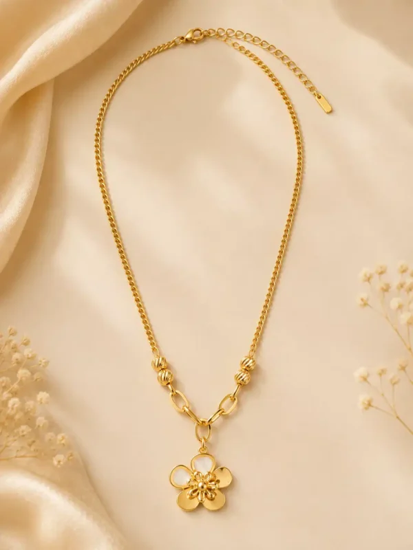 Full-length Elara Bloom gold flower necklace laid flat with lobster clasp, extension chain, textured beads and floral pendant visible