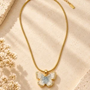 Azure Flutter anti-tarnish crystal butterfly necklace with gold-tone snake chain and blue and clear crystals