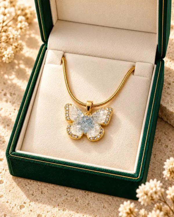 Crystal butterfly necklace displayed in a premium green jewellery box with gold-tone snake chain