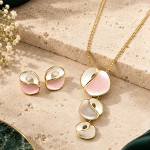 Blush Orbit anti-tarnish gold-tone pendant necklace and matching stud earrings with blush pink and pearly white abstract details