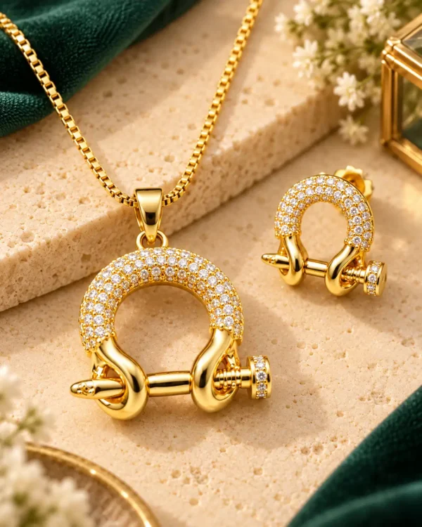 Close-up of Aurelia gold-plated link pendant and matching stud earring with clear pavé crystals