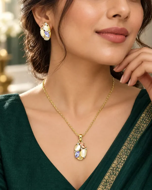 Woman wearing gold-tone pastel stone pendant necklace and matching earrings with an emerald green outfit